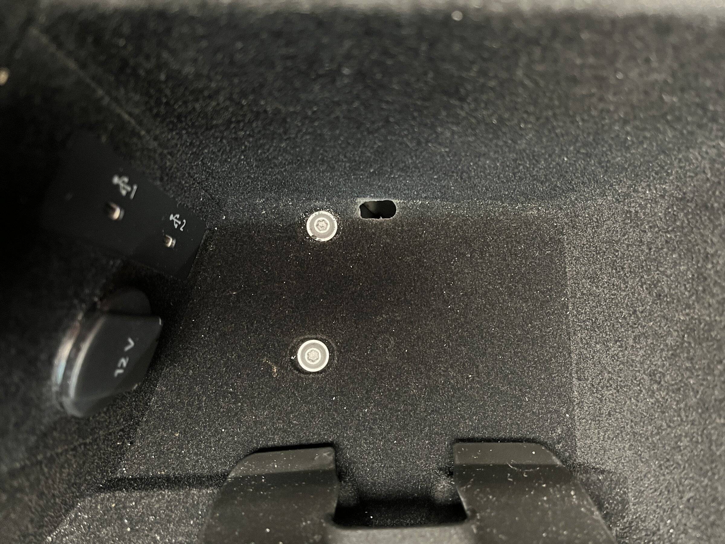 Porsche Taycan Routing Magsafe cable from passenger side of console to USB C port OvalCableHole.JPG