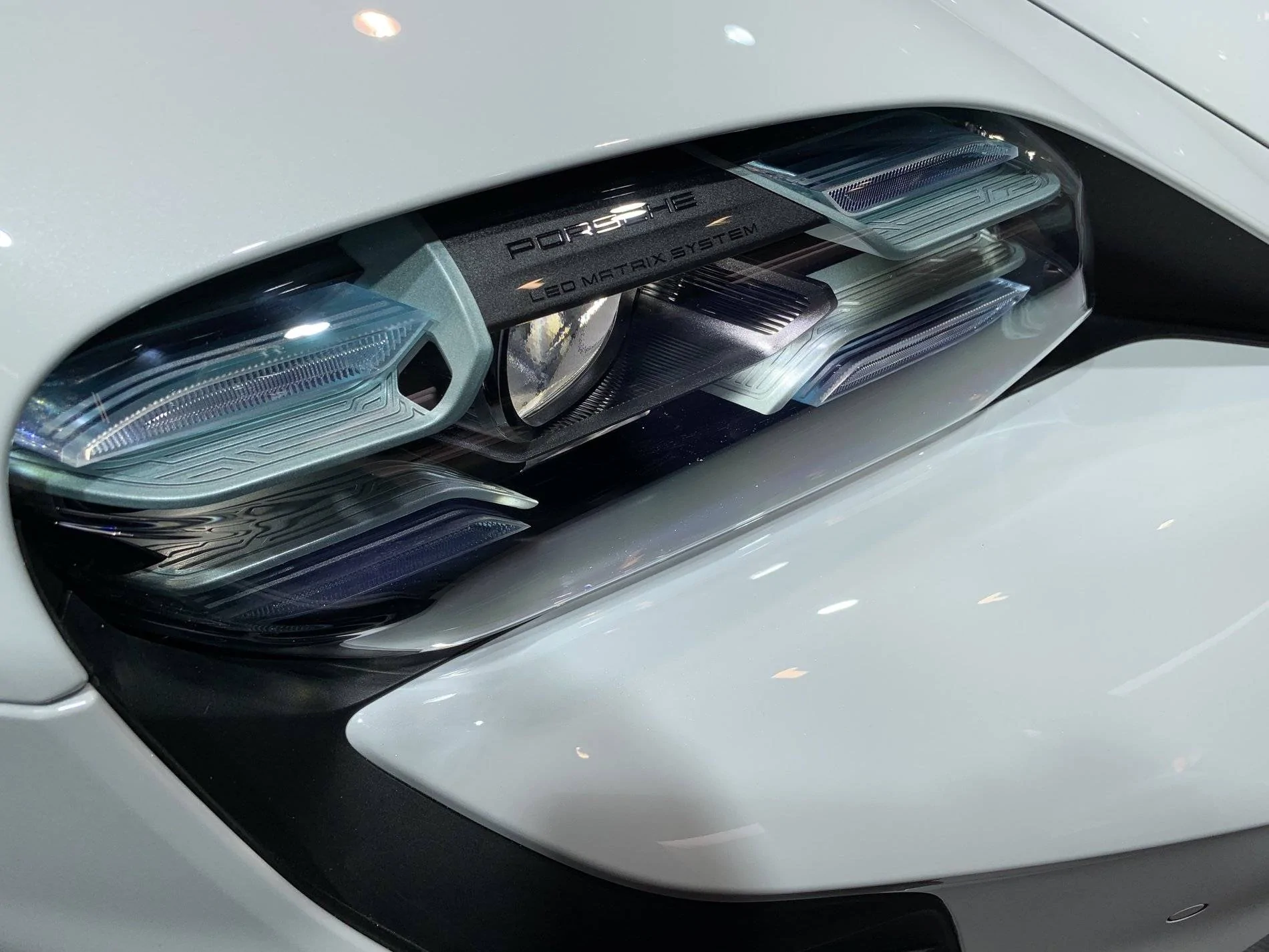 Porsche Taycan Close up view of headlights - LED-Matrix PDLS+: black vs blue? iceblu