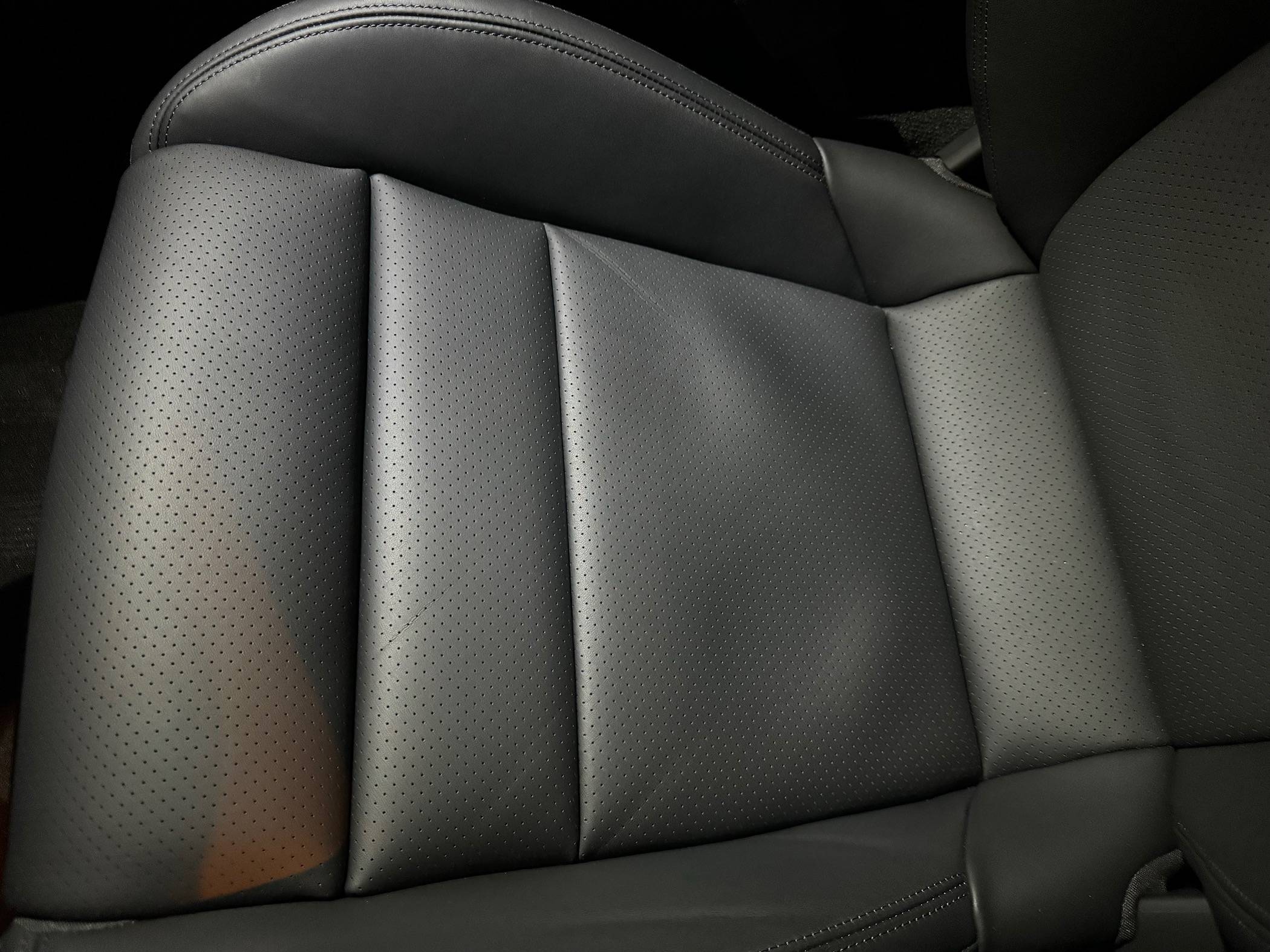 Porsche Taycan Loose leather at base of seat IMG_0347