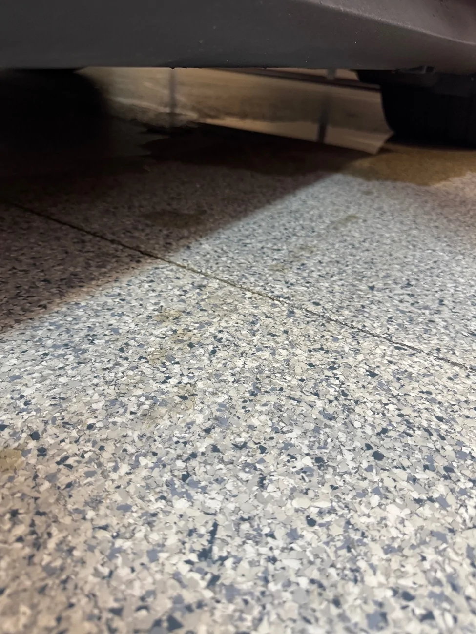 Porsche Taycan Water puddle in garage after rain IMG_0957